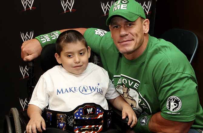 In this Monday, June 18, 2012 photo, seven-year old, Jonny Littman, poses with WWE superstar, John Cena, at the 300th Make-A-Wish for Cena in Uniondale, N.Y. It was the 300th wish granted by Cena, making him the most popular celebrity granter in Make-A-Wish history. 