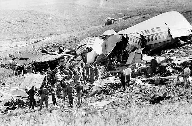 This May 23, 1962 file photo shows officials searching the wreckage of Continental Airlines Flight 11 which crashed near Unionville, Mo. Aviation buffs know Flight 11 as the country's first bombing of a commercial jet airliner, an act of sabotage by a passenger that killed all 45 people on board. Yet the crash of the plane, which departed Chicago en route to Los Angeles with a Kansas City stop, was largely forgotten as time passed, families moved on and more horrific airline incidents came to dominate history.