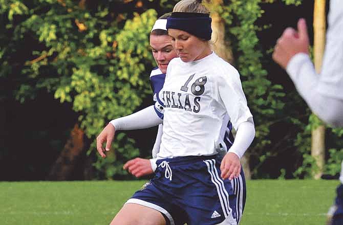 In this News Tribune file photo, Helias senior defender Madi Nichols goes for the ball during a game this season. Nichols was one of seven Lady Crusaders named to the All-State teams.