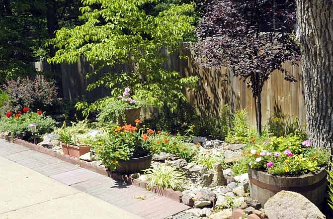 Richard and Marcia Hartman's yard at 205 Woodward Lane includes many interesting flower beds. Their Jefferson City yard was named Yard of the Month for June. 