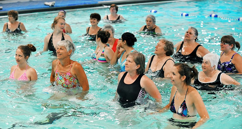 Mikayla Morris, front right, works out next to Pat Grothoff while classmate Kendra Sanches, front row left, and Nancy Wilbers keep up with the instructor. Some students in summer school at Jefferson City High School have spent their physical education class time in the pool at the Knowles YMCA in water aerobics class.