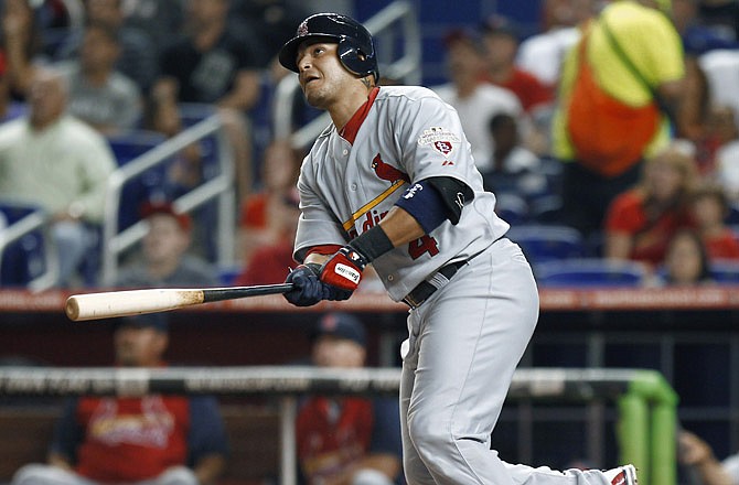 The Cardinals' Yadier Molina watches his three-run home run during the first inning of Tuesday's game against the Marlins in Miami. The Cardinals won their fifth straight game with a 5-2 win. 