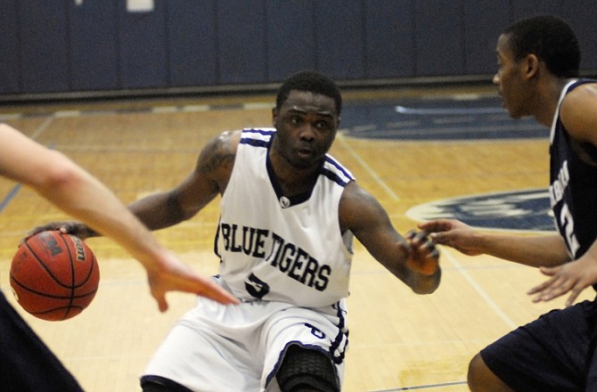 Lincoln's Clifton Fleming dribbles during a game last season. The Blue Tigers released their men's basketball schedule Tuesday.