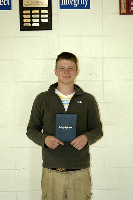 Austin Boelkes with his CHS diploma presented at the regular California R-I School Board meeting on June 19.