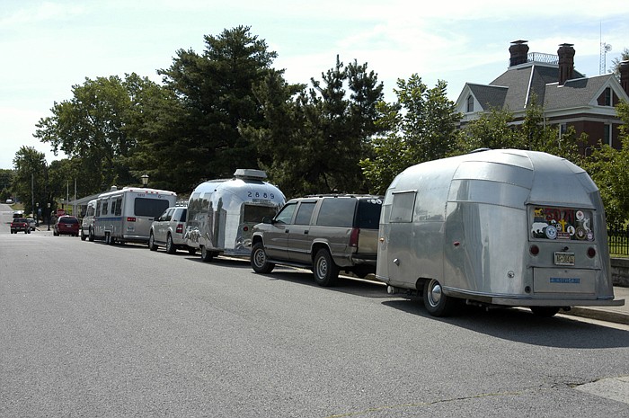 One of the older trailers on the road for this Vintage Club tour is on the right. The box style trailer at the left is one which was made only a few years.
