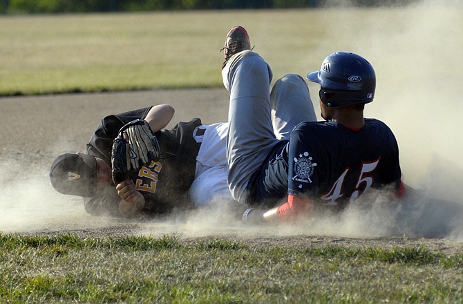 Michael Washington of the Jefferson City American Legion Post 5 Seniors slides into third as Versailles third baseman Rock Curry loses control of the baseball during Wednesday's game at the American Legion Sports Complex.