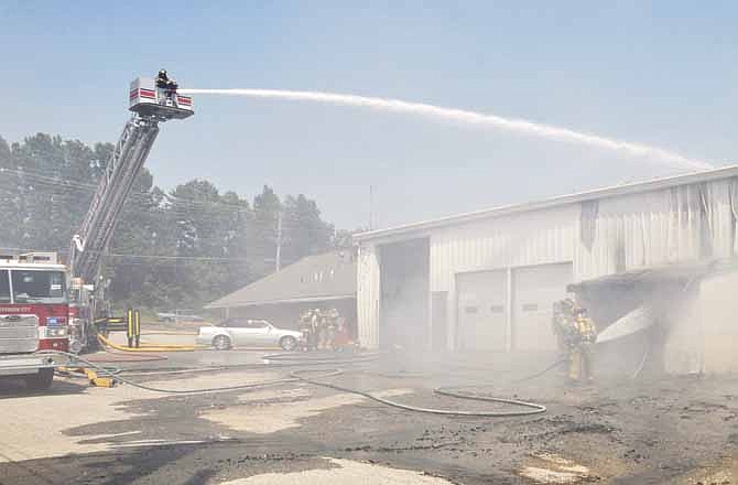 Jefferson City firefighters battle a blaze at Propst Auto Repair on Industrial Drive Wednesday afternoon.