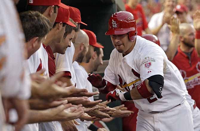 St. Louis Cardinals' Allen Craig (21) celebrates with teammates after hitting a three-run home run in the third inning of a baseball game against the Pittsburgh Pirates, Friday, June 29, 2012, in St. Louis.