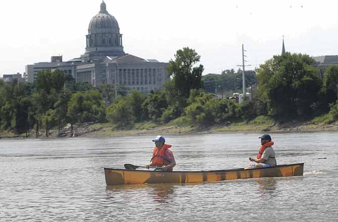Friends Andy Neidert and Clint Barnett, both of Jefferson City, are the first canoe to pull in to the Noren Access on the Missouri River during 2012's third annual Race to the Dome. 