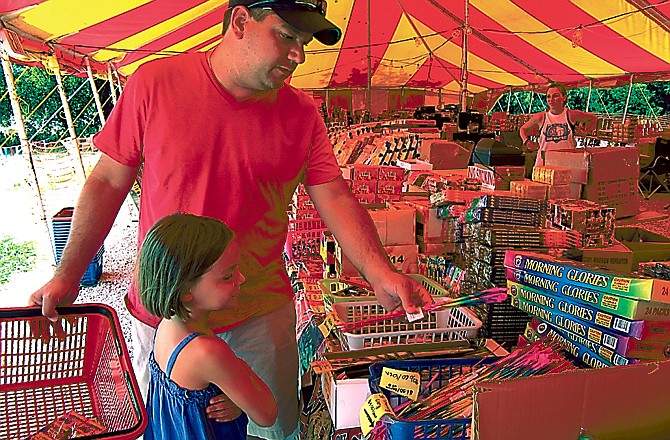 George Welling and daughter Shelby, 6, shop for fireworks July 1, 2012 at a fireworks stand in Cole County.
