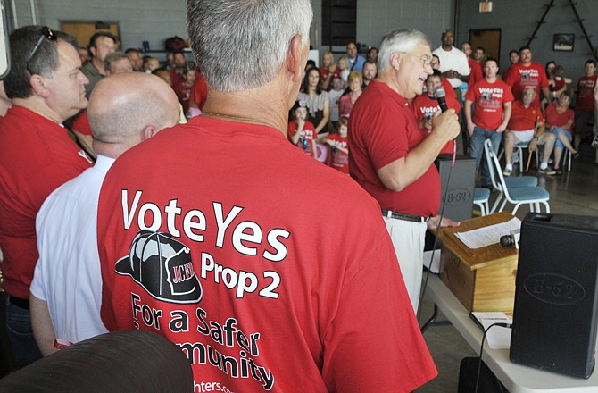 Asst. Chief Lonnie Brandt sports a T-shirt with the "Vote Yes on Prop 2" as citizens committee member Dr. Bryan Pope talks about the plans to inform the community of the proposed tax increase involved in Proposition 2.