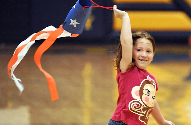 Anna Jutting runs with her wind sock during camp Monday at Trinity Lutheran Church. They are hosting "Happy Birthday, America!" themed camp this week and students are participating in several activities, based on their ages.