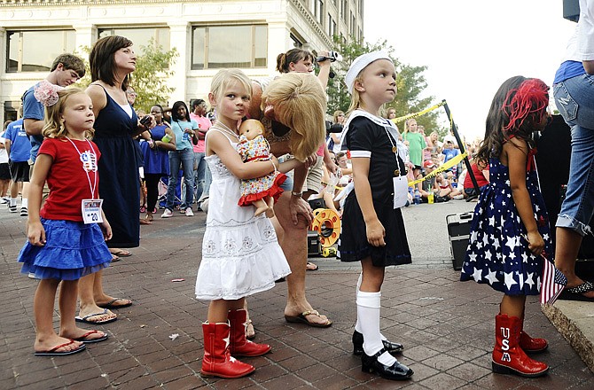 Young contestants wait in line before taking the stage during the Little Miss Independence contest on Tuesday.