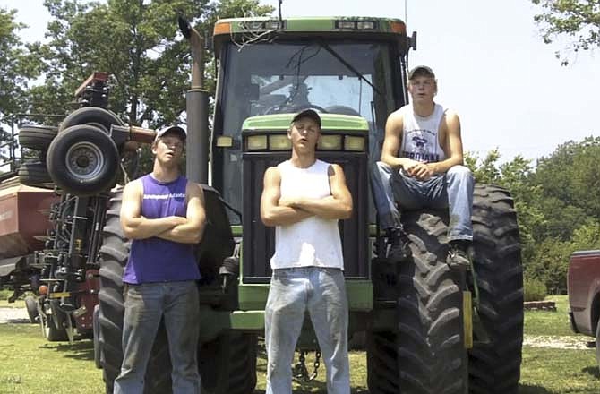 This frame grab from video shows Assaria, Kan., brothers, from left: Nathan; Greg and Kendal Peterson in their video parody on LMAFO's "Sexy and I Know It." The parody, that has gone viral on YouTube and Facebook, shows the three brothers rapping their farming mission on the family's Saline County farm.