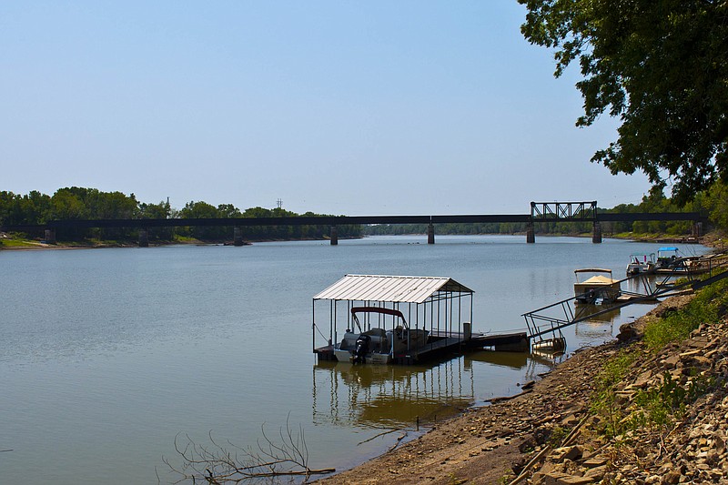 Construction for the new railroad bridge, above, in Osage City is not progressing as planned at a stand still as the Osage River water levels keep dropping, not allowing the crane barge, right, to get to the bridge. 