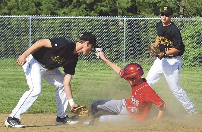 In this News Tribune file photo, St. Elizabeth shortstop Ryan Loethen (left) puts a tag on Calvary-Tolton's Brad MacLaughlin during a game last season at Calvary Lutheran Lions Field. Loethen has been named a Class 1 all-state selection by the Missouri Sportswriters and Sportscasters Association. 