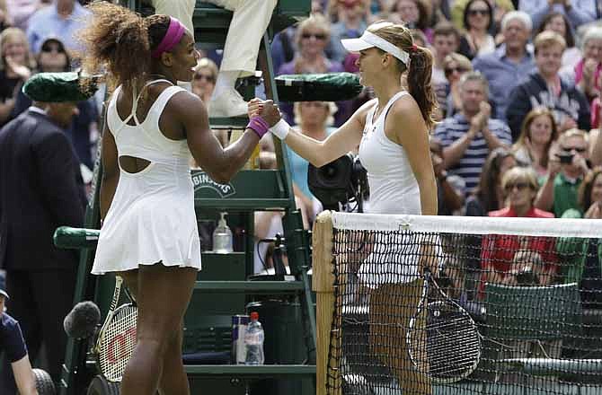 Serena Williams of the United States, left, is congratulated by Agnieszka Radwanska of Poland after winning the women's final match at the All England Lawn Tennis Championships at Wimbledon, England, Saturday, July 7, 2012. 