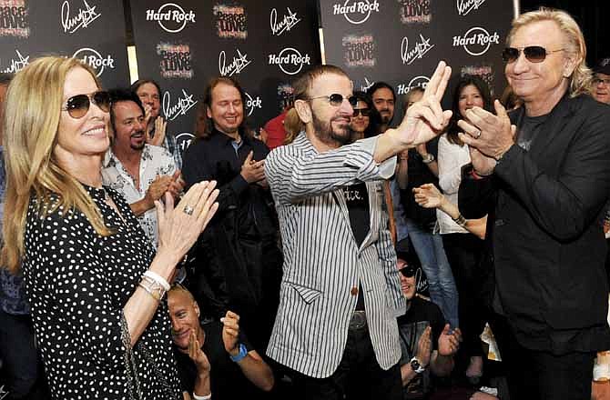 In this photo provided by Rob Shanahan, musician Ringo Starr, center, celebrates his 72nd birthday with his wife Barbara Bach, left, and musician Joe Walsh, right, at The Hard Rock Cafe, Saturday, July 7, 2012, in Nashville, Tenn.