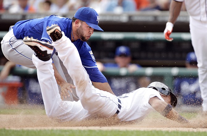 Kelvin Herrera of the Royals tags out Quintin Berry of the Tigers at the plate during the seventh inning of Sunday's game in Detroit.