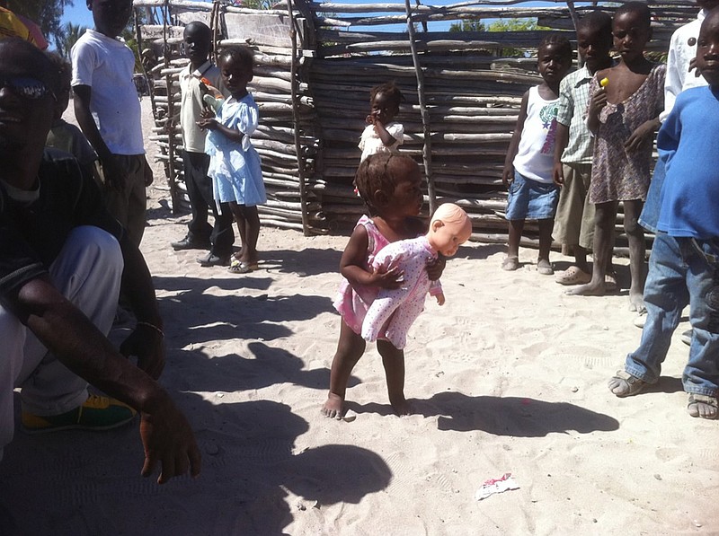 A child receives a toy from Victory Fellowship Church missionaries last year in the  Haitian villiage of Ti Anse. The church will be holding its first-annual Hopefest event, which will raise funds to send 20,000 meals to the Caribbean nation.