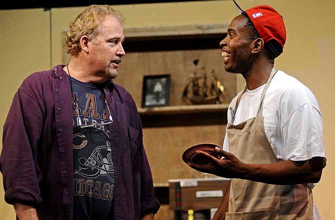 Shop owner Arthur Przybyszewski, played by Tom Durkin, listens as his lone employee, Franco Wicks, played by Dingani Beza, wistfully envisions a bright new future for their small, decrepit donut shop in Chicago's Uptown neighborhood during a rehearsal for the Capital City Players' production of "Superior Donuts" at Shikles Auditorium