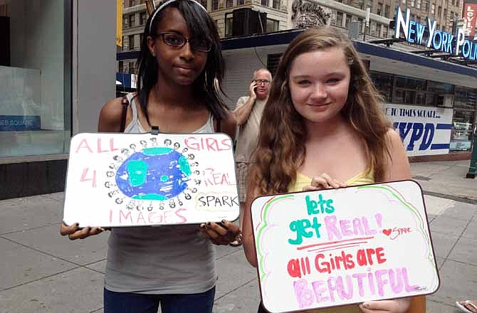 Britney Franco, 13, of the Brooklyn borough of New York, left, poses with Hannah Stydahar, 14, of Croton-on-Hudson, N.Y. during a protest Wednesday, July 11, 2012, near the offices of Teen Vogue in the Times Square section of New York. Days after a campaign led by a 14-year-old girl secured a promise from Seventeen magazine not to alter body shapes in photographs, more teens protested against Teen Vogue on Wednesday. 