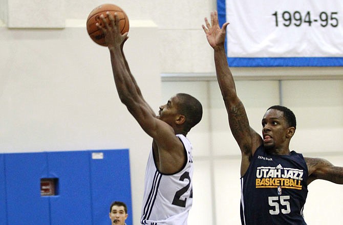 Kim English of the Pistons drives past Kevin Murphy of the Jazz during an NBA summer league Monday in Orlando, Fla.