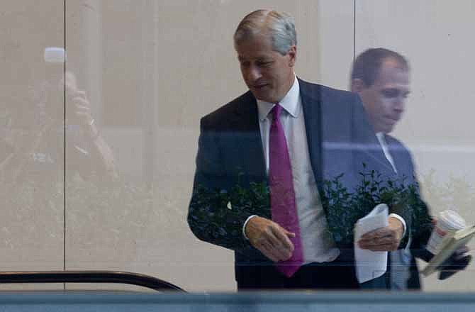 JPMorgan Chase CEO Jamie Dimon enter the company's headquarters in New York Friday, July 13, 2012. JPMorgan Chase, the largest bank in the United States, said Friday that its loss from a highly publicized trading blunder had grown to $5.8 billion.
