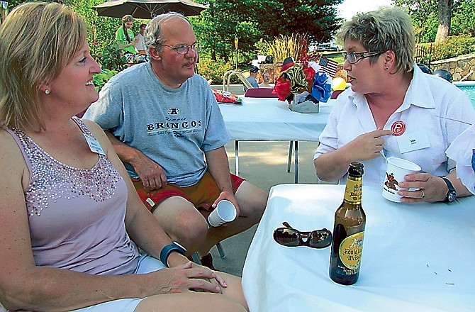 From left, Marylin Kliethermes and her brother, Glen Kliethermes, chat with Ute Geller, who recently retired after a 40-year teaching career in Lank, Germany. They were among several dozen people who attended a pool party on Sunday as part of a German Heritage Society event. The Loose Creek-based society visits its German ancestors every four years, and welcomes its German counterparts every four years. This year, about 25 families are hosting 45 German residents.