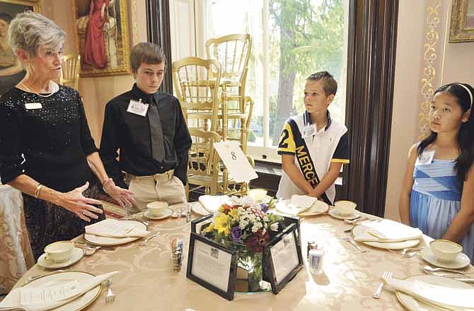 Verna Luebbert works with youngsters during Thursday's manners class at the Missouri Governor's Mansion. They were part of the group learning manners for everyday use. Next to Luebbert is Jason Stewart from Williamsburg, Christopher Link from Columbia and Sarah Wieberg from Westphalia.