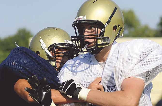 Helias' Hale Hentges works through a block during the final day of the Crusaders' football camp Friday. 