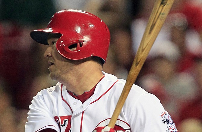 Scott Rolen of the Reds watches his two-run single in the eighth inning of Sunday's 4-2 win over the Cardinals in Cincinnati.