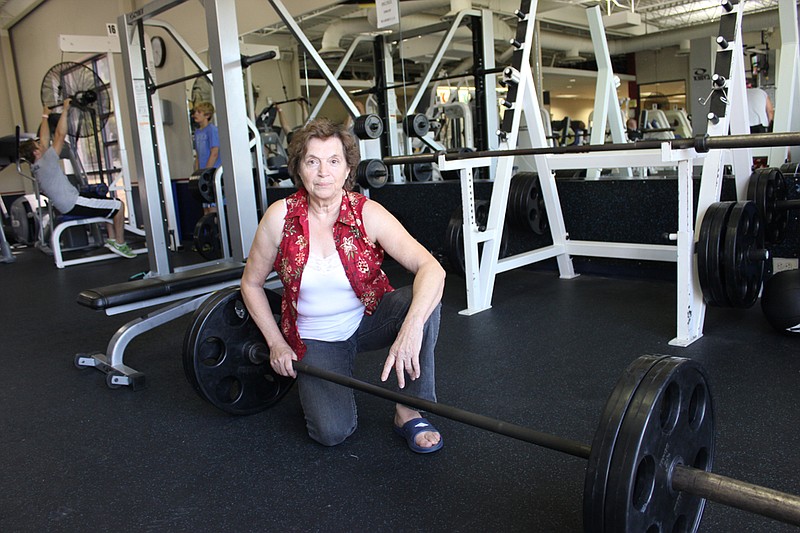 Lenna Barker poses with her weights at the Callaway County YMCA. The 71-year-old grandmother is headed to world championships this year, and aims to break the most records for someone in her age range.