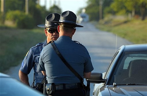 Sgt. JP Angle talks with Lt. Scott Meyer Sunday evening, July 15, 2012, at a road block near Trimble, Mo. Law enforcement were conducting a second search for missing Edgerton, Mo. sisters, Britny Haaru, ,19 and Ashley Key 22, whose bodies were found that evening.