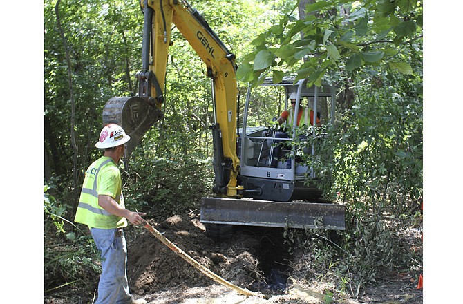 Workers dig out earth Monday along U.S. 54 between Routes F and H for new fiber optic cable installations in Callaway County and across the state. The cables, owned by Bluebird Network, will benefit area hospitals, schools, government institutions and service providers.