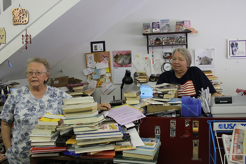 Jinx Books owner Kathryn Wade, left, and employee Laura Scott. Wade has put Fulton's book store of 12 years up for sale in order to retire.