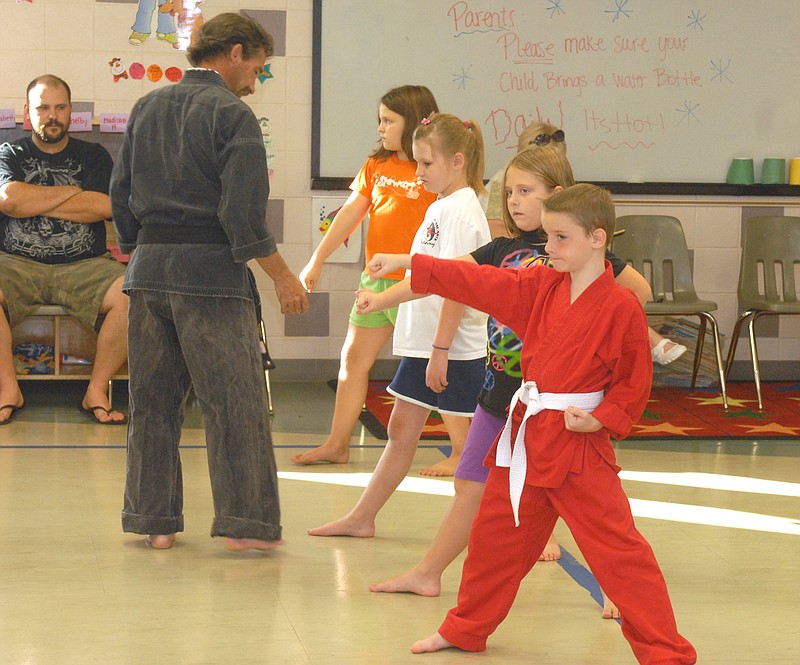 Instructor Andrew Rackers watches as the kids demonstrate some basic technique during the American Karate kids class held at the Knowles YMCA. The Show-Me State Games American Karate and Tae Kwon Do competition will be Saturday at the Firley YMCA. 