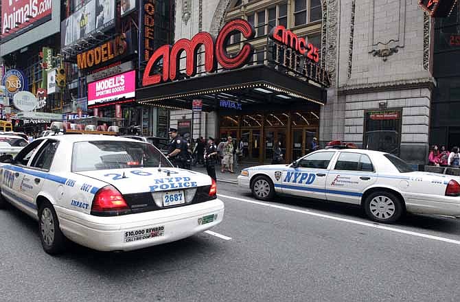 Police officers are seen outside a movie theater screening "The Dark Knight Rises," Friday, July 20, 2012 in New York. NYPD commissioner Ray Kelly said the department was providing the extra security at theaters following shootings in a Colorado theater "as a precaution against copycats and to raise the comfort levels among movie patrons." 