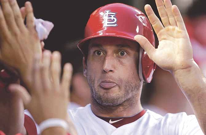 St. Louis Cardinals' David Freese celebrates with teammates ater scoring on a single by teammate Rafael Furcal in the seventh inning of a baseball game on Saturday, July 21, 2012, in St. Louis.
