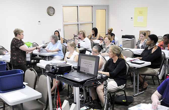 The South Campus Conference Center was the setting Thursday for a Parents As Teachers training course, at which Karen Berding, third from left, served as facilitator. Berding is a national trainer for the National Center for Parents As Teachers. This room is set up to comfortably hold up to 50 people.