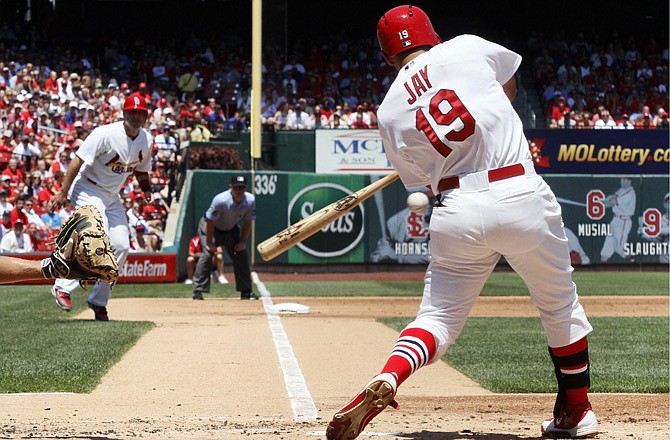 The Cardinals' Jon Jay drives in Allen Craig from third base with a two-run double in the first inning against the Cubs on Sunday in St. Louis. The Cardinals won 7-0 and have won three straight games.