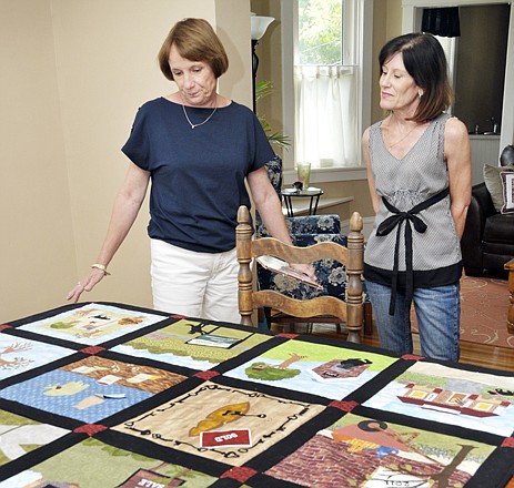 Illustrator Delia Gresham, left, and author Anita Lael talk about the process of writing and illustrating the book via long-distance communications. Gresham lives in Springfield and was sent photos for designs for the patchwork quilt and book written about Lael's historic preservation project. 