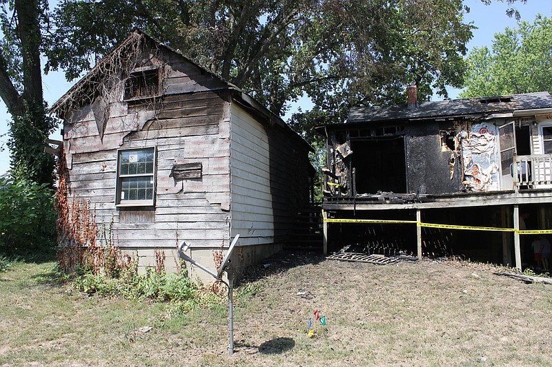 206 Addison St. stands charred from an accidental fire July 23, caused by a spark from a grill that ignited wooden building materials kept underneath the back porch.