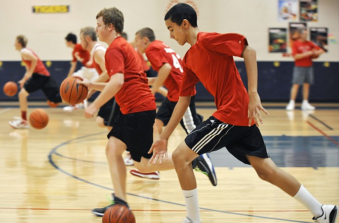 Ross Schlichting (front) and his Calvary Lutheran High School teammates go through ballhandling drills during a camp session Tuesday at Trinity Lutheran.