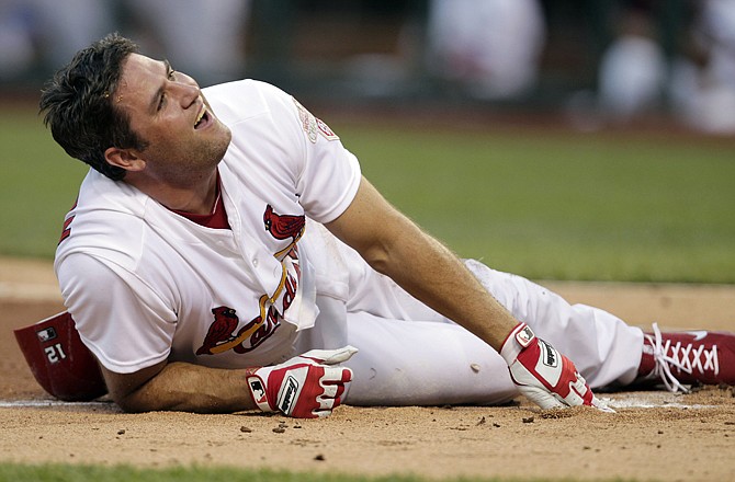 The Cardinals' Lance Berkman writhes in pain after being hit in the leg by a pitch from Dodgers starter Clayton Kershaw in the third inning Tuesday in St. Louis.
