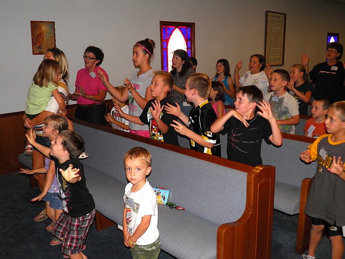Children sing "This Little Light of Mine" during worship.