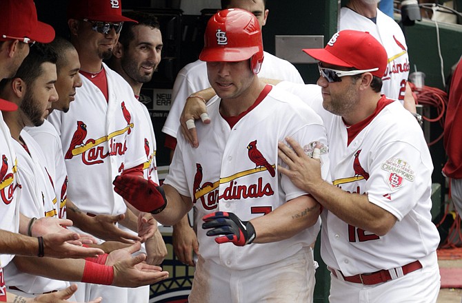 The Cardinals' Matt Holliday (7) is congratulated by Lance Berkman (right) and others after hitting a solo home run in the sixth inning against the Dodgers on Thursday in St. Louis. The Cardinals won 7-4.