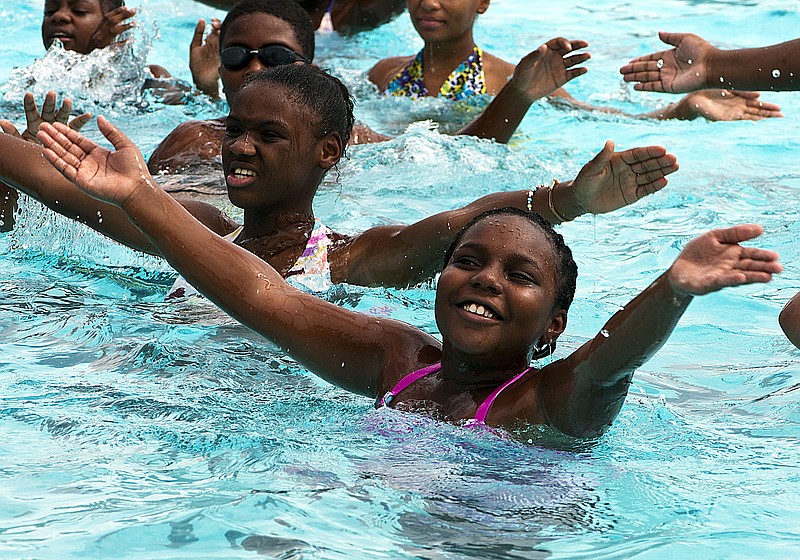 Aaliyah Patterson, 10, and other participants in the Boys & Girls Club's Fit Kids Camp partake Thursday in water aerobics and exercise swimming at Riverside Pool. 