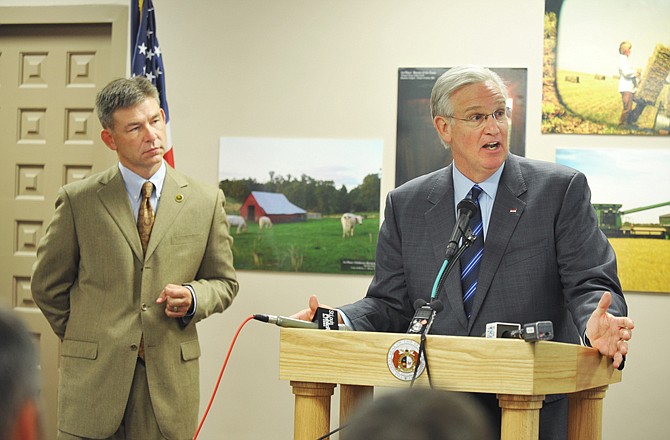 Gov. Jay Nixon holds a news conference to announce the addition of $5 million to help Missouri farmers dealing with this summer's drought conditions. At left is department director Jon Hagler.