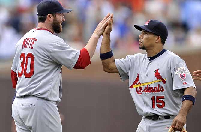 St. Louis Cardinals closing pitcher Jason Motte, left, celebrates with teammate Rafael Furcal after defeating the Chicago Cubs 9-6 during a baseball game in Chicago, Friday, July 27, 2012.